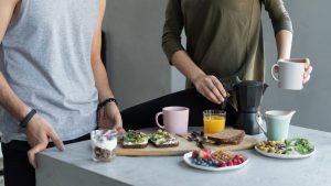 Cozy morning breakfast with avocado toast, coffee, and fresh juice.